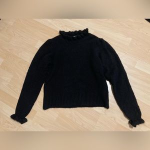 Black sweater with ruffled neck and sleeves
